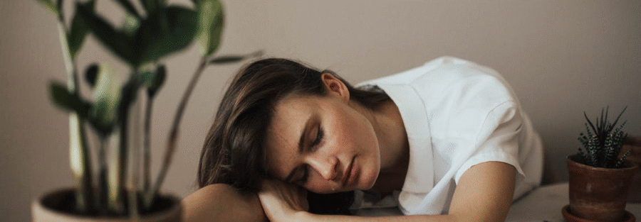 A woman resting her head on a table
