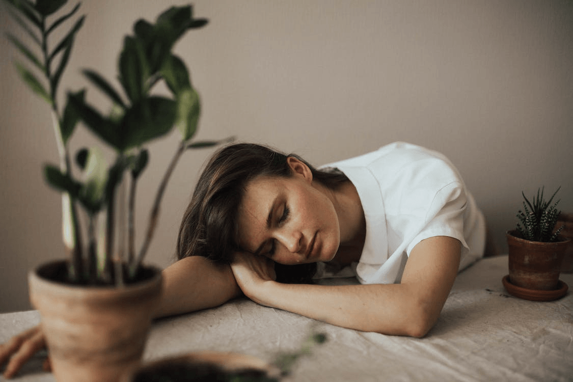 A woman resting her head on a table