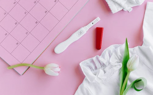 pregnancy test kit on pink background