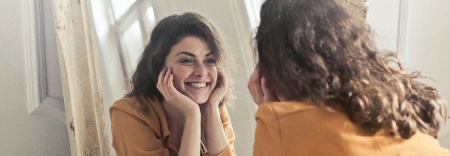 Woman smiling after getting Hormone Replacement Therapy