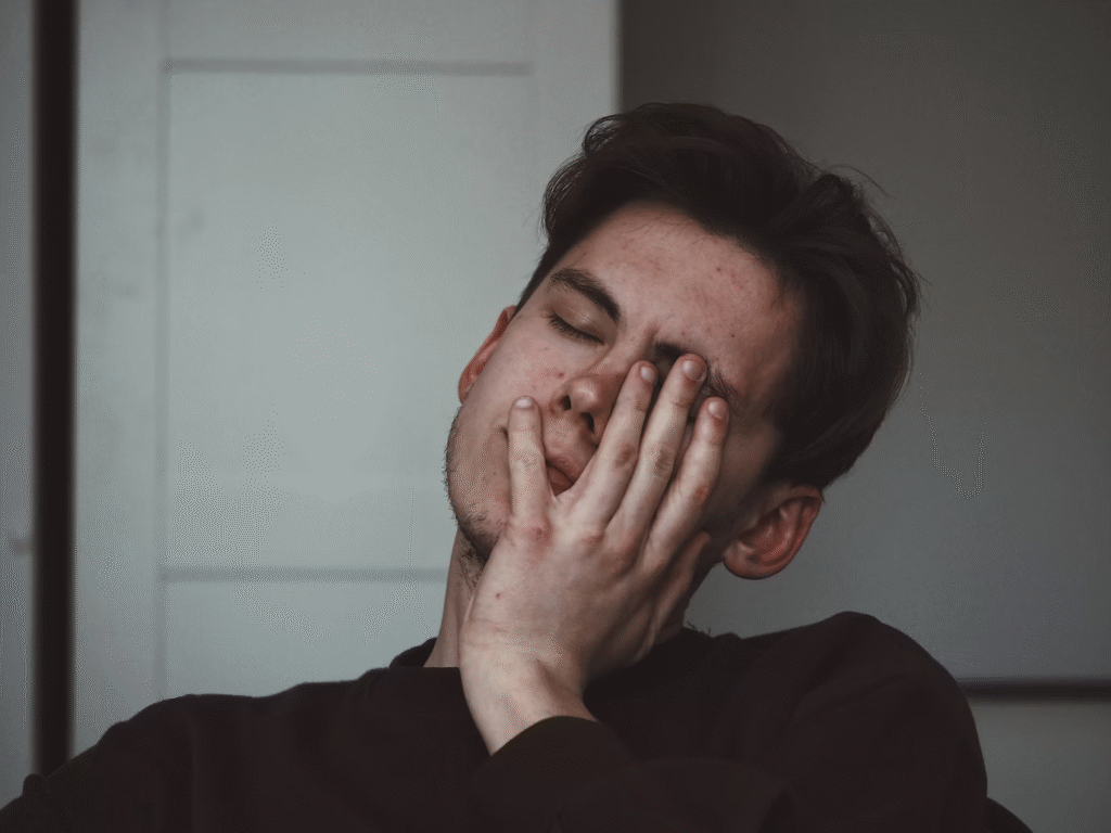A young man with imbalanced hormones and health problems looks distressed