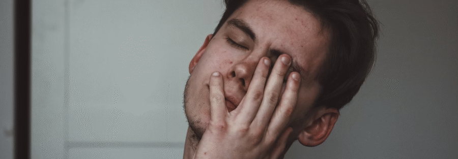 A young man with imbalanced hormones and health problems looks distressed