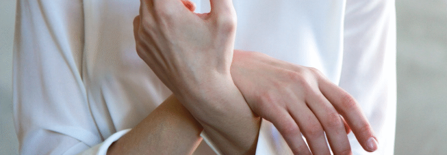 Closeup of a woman in long white sleeves