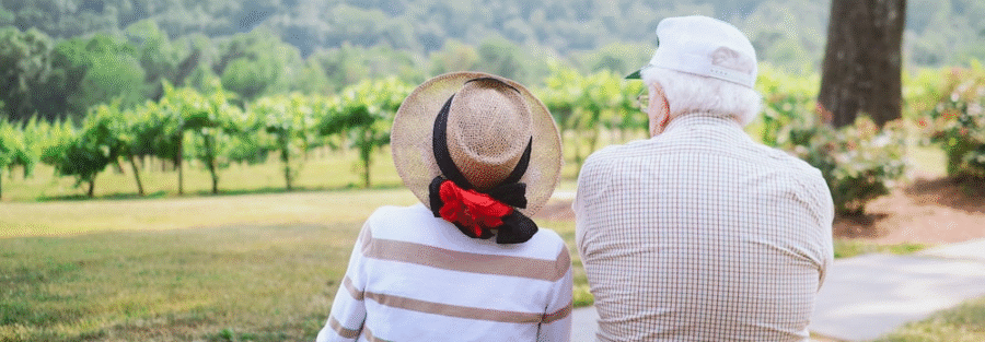 an old couple sitting in a park